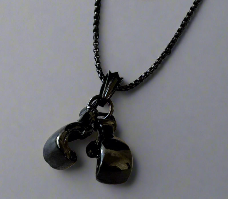 For the sporting man. A black chain with a pair of boxing gloves. In a Beecham gift box brought to you by kenny k. 