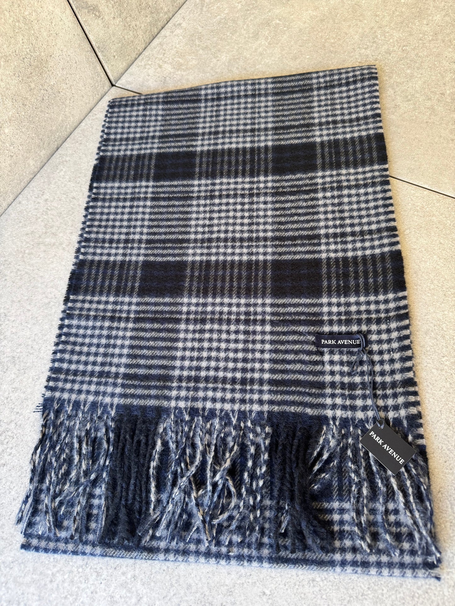 Elevate your style with Park Avenue Scarves brought to you by kenny k. These stylish scarves are made from 100% recycled polyester, keeping you warm and environmentally conscious. Featuring a classy fringe and a generous 180cm length, they are the perfect addition to any outfit. Stay fashionably cosy and eco-friendly with Park Avenue Scarves.