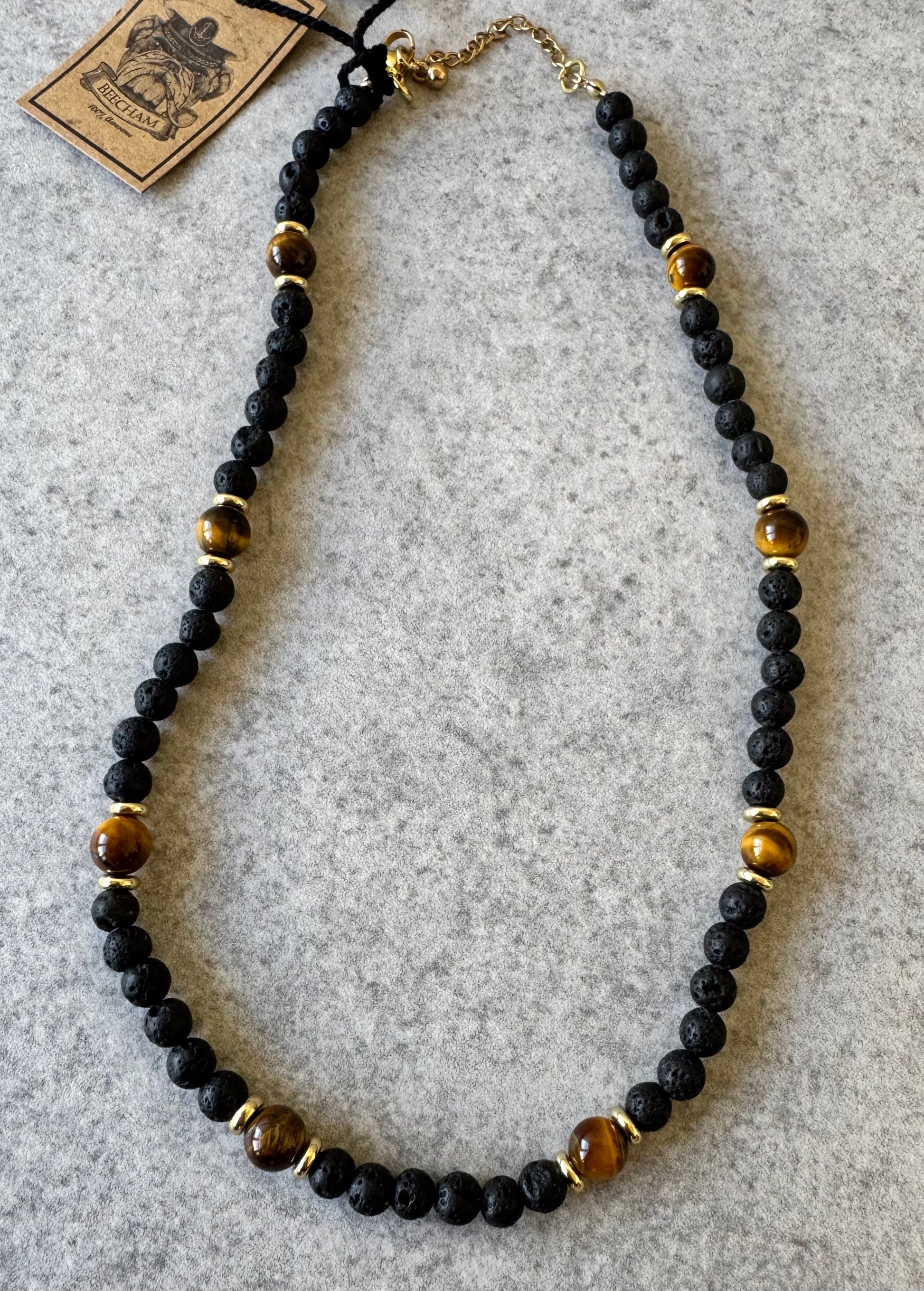 Beecham necklace brought to you by kenny k., &nbsp;the perfect gift for the laid-back guy in your life! This necklace is not only awesome, it's an awesomely fashionable way to show off his style. Presented in a Beecham gift box. Tigers Eye Lava Stone.