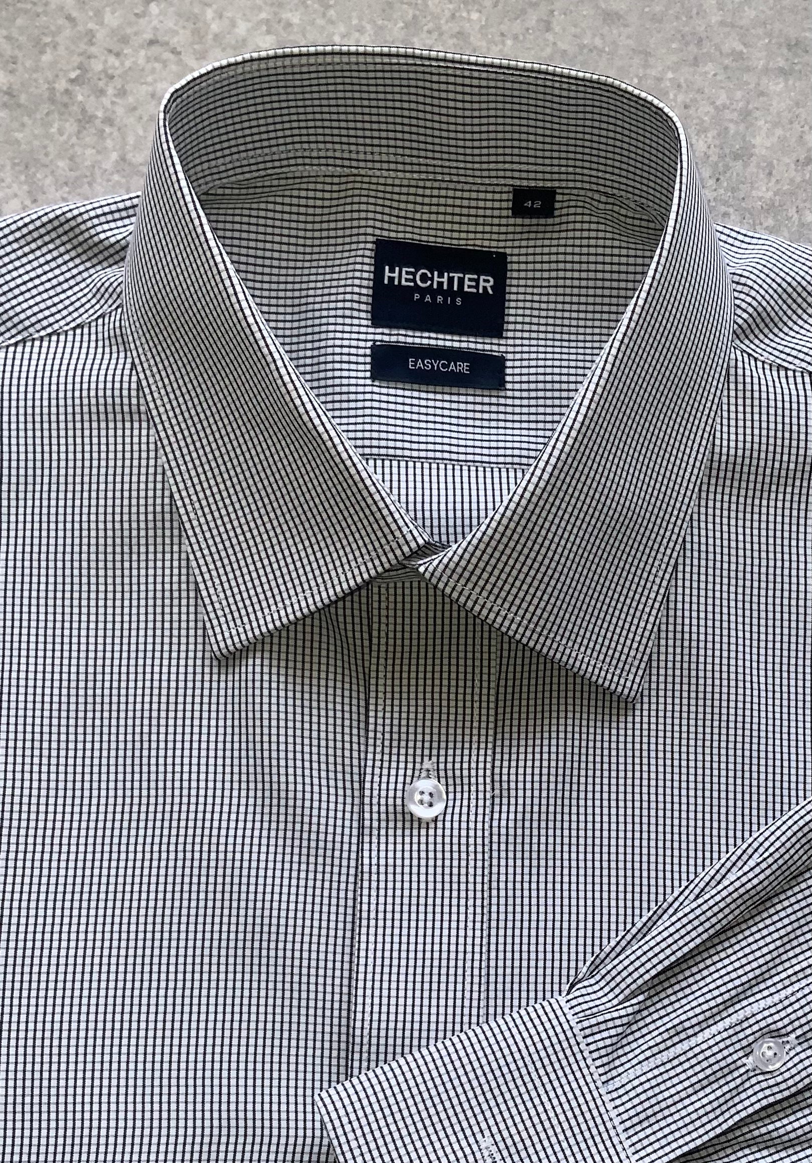 Classic style meets modern tailoring with Liberty black and white check business shirt. Designed for versatility and comfort, this shirt features a crisp check pattern that transitions effortlessly form the boardroom to after hours. Crafted from a breathable cotton/polyester blend, it delivers all day wearability with a polished, professional finish. The structured collar and button up design make it ideal for pairing with tailored trousers, chinos or layered under a blazer.