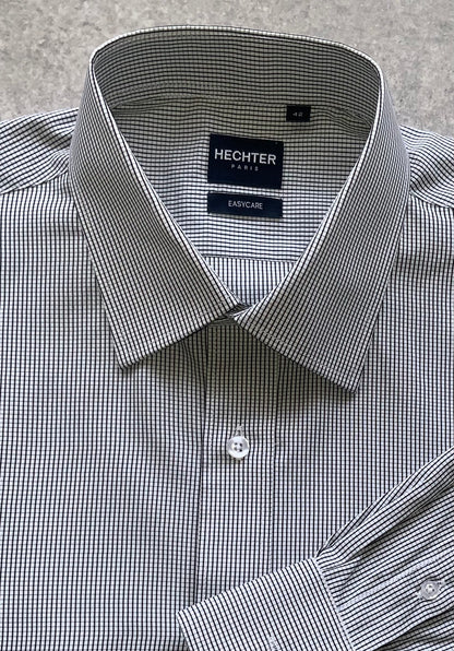 Classic style meets modern tailoring with Liberty black and white check business shirt. Designed for versatility and comfort, this shirt features a crisp check pattern that transitions effortlessly form the boardroom to after hours. Crafted from a breathable cotton/polyester blend, it delivers all day wearability with a polished, professional finish. The structured collar and button up design make it ideal for pairing with tailored trousers, chinos or layered under a blazer.