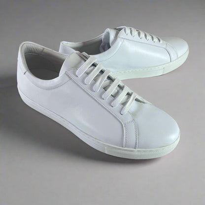 Crafted with premium leather inside and out, the Classic Calmino Leather sneaker delivers exceptional durability and comfort. The timeless white design offers versatile styling options while the quality construction ensures proper foot support and breathability. These sneakers combine traditional craftsmanship with everyday wearability for discerning footwear enthusiasts.