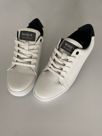 Introducing the essential white sneaker by Connor &amp; Kenny K. Made from high-quality faux leather, these sneakers are stylish and a basic essential for business and leisure. With their classic white design, they are perfect for any outfit and any occasion. Upgrade your footwear game with these must-have sneakers.