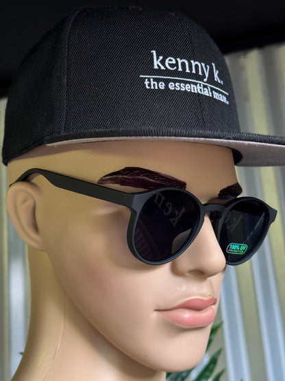 Mannequin head wearing a black cap with 'kenny k' branding and black sunglasses.