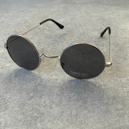 Round John Lennon style sunglasses with black lenses and silver frames.