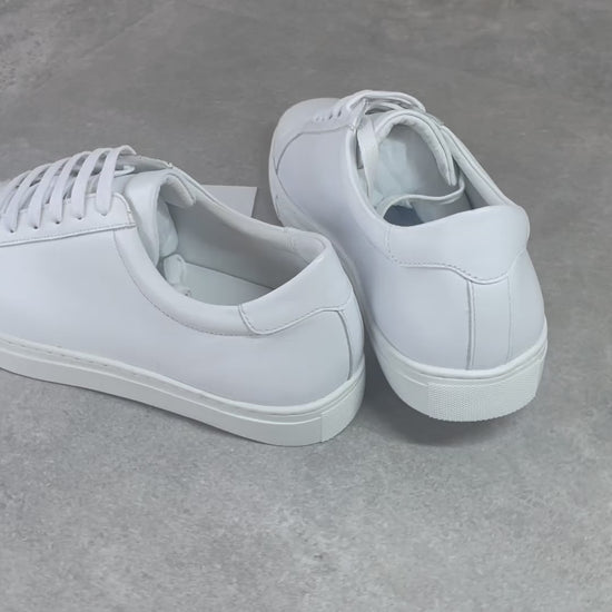 Crafted with premium leather inside and out, the Classic Calmino Leather sneaker delivers exceptional durability and comfort. The timeless white design offers versatile styling options while the quality construction ensures proper foot support and breathability. These sneakers combine traditional craftsmanship with everyday wearability for discerning footwear enthusiasts.