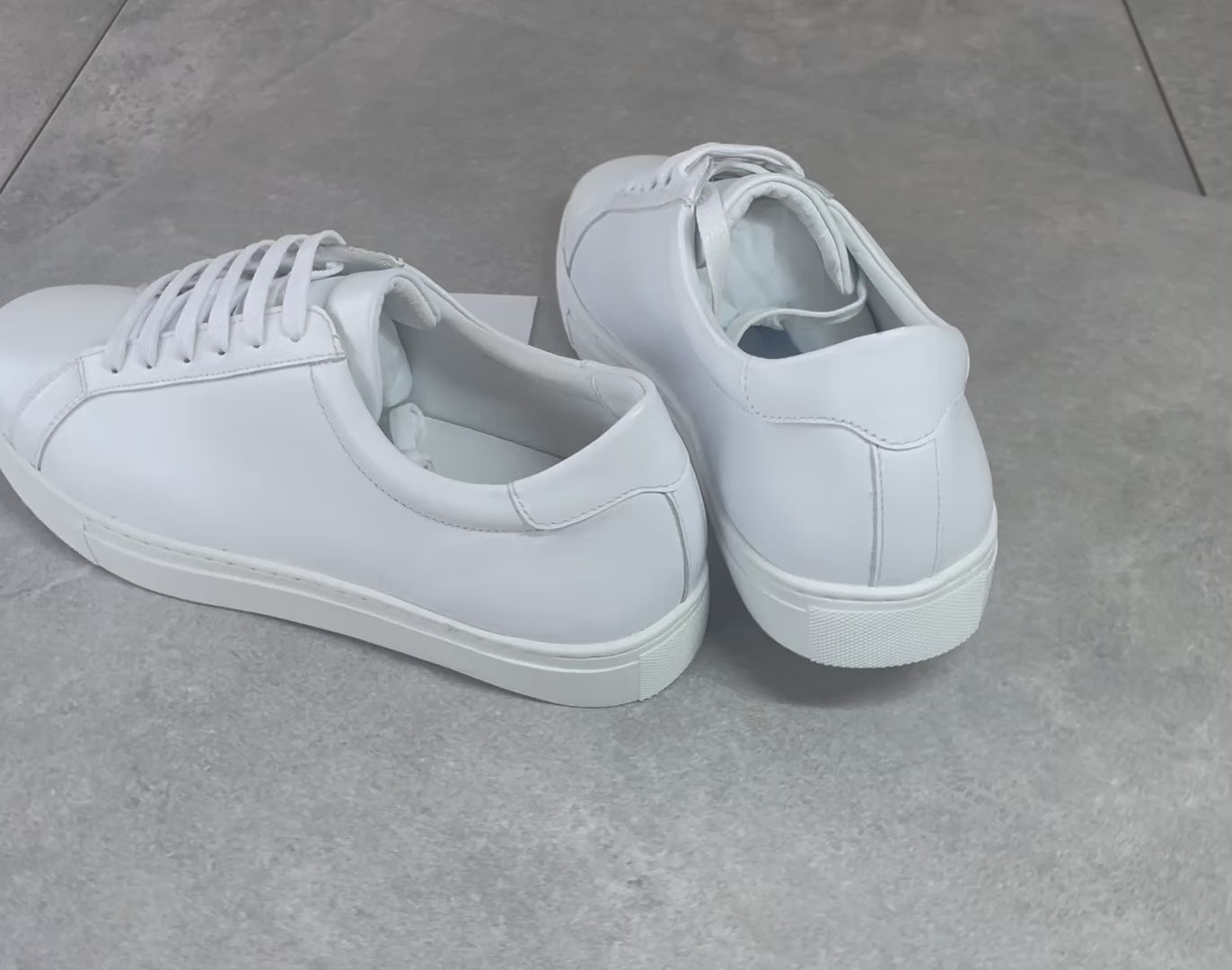 Crafted with premium leather inside and out, the Classic Calmino Leather sneaker delivers exceptional durability and comfort. The timeless white design offers versatile styling options while the quality construction ensures proper foot support and breathability. These sneakers combine traditional craftsmanship with everyday wearability for discerning footwear enthusiasts.